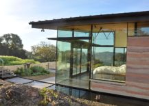 Bedroom-with-glass-walls-flows-into-the-patio-outside-217x155
