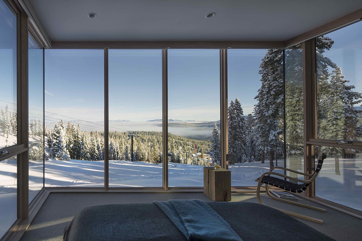 Bedroom with glass walls offer gorgeous view of the snowy mountain slopes