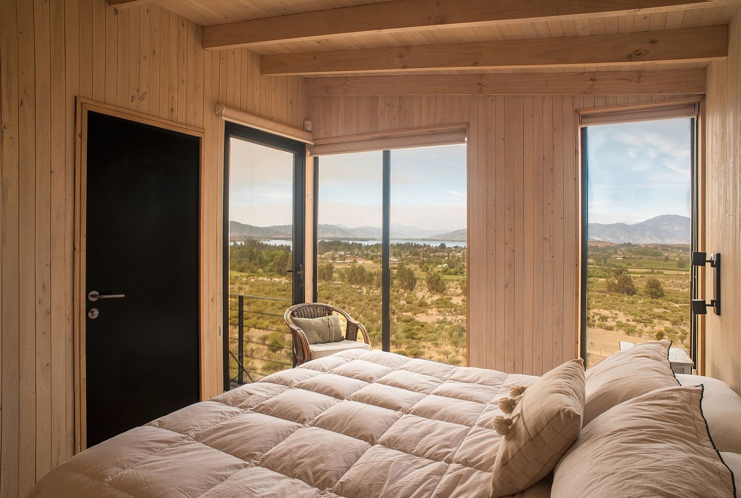 Bedroom with lovely lake view and a simple design style