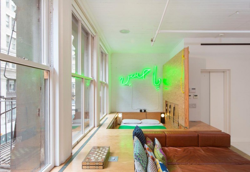 Big neon sign as a focal point in a bedroom corner