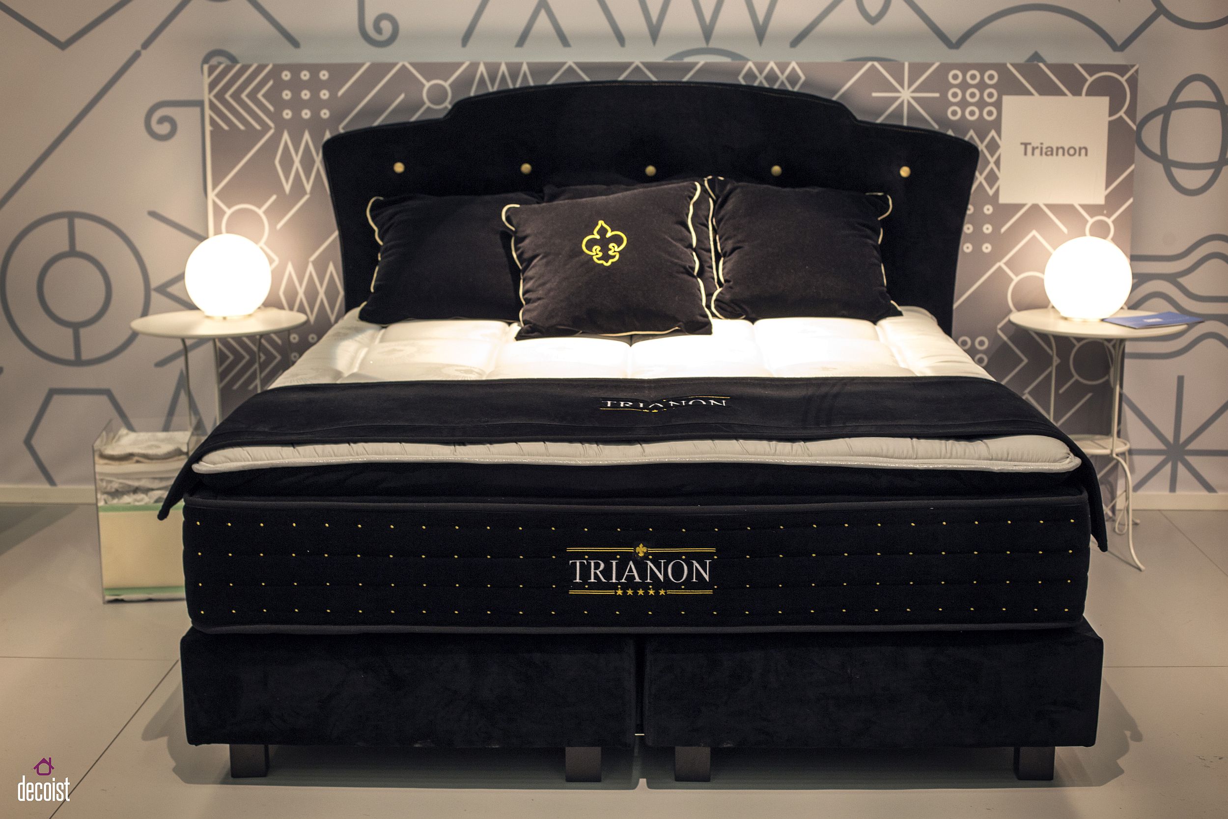 Black bed and ornate headboard make big visual impact in abedroom clad in neutral hues