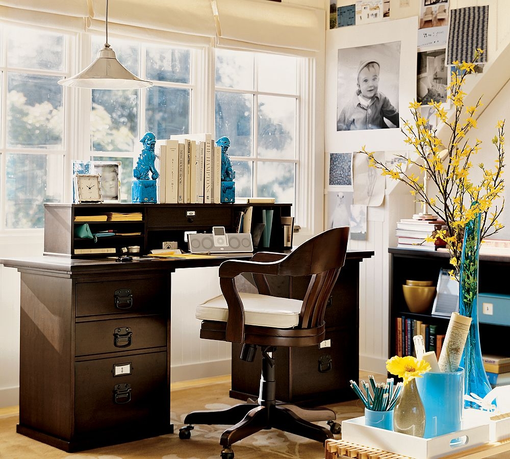 Bold and bright colors in a home office with dark wood furniture