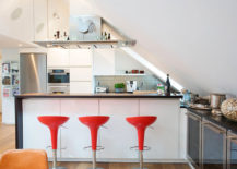 Bold-red-stools-as-an-unconventional-decor-in-an-attic-kitchen--217x155