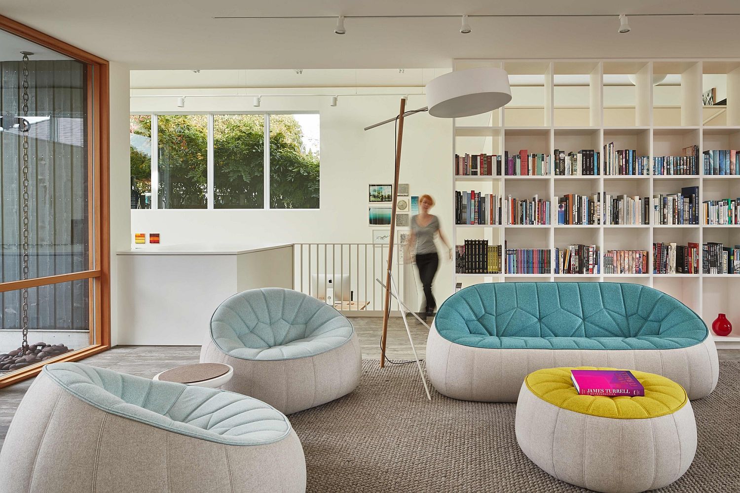 Bookcase along with decor adds color to the neutral living room