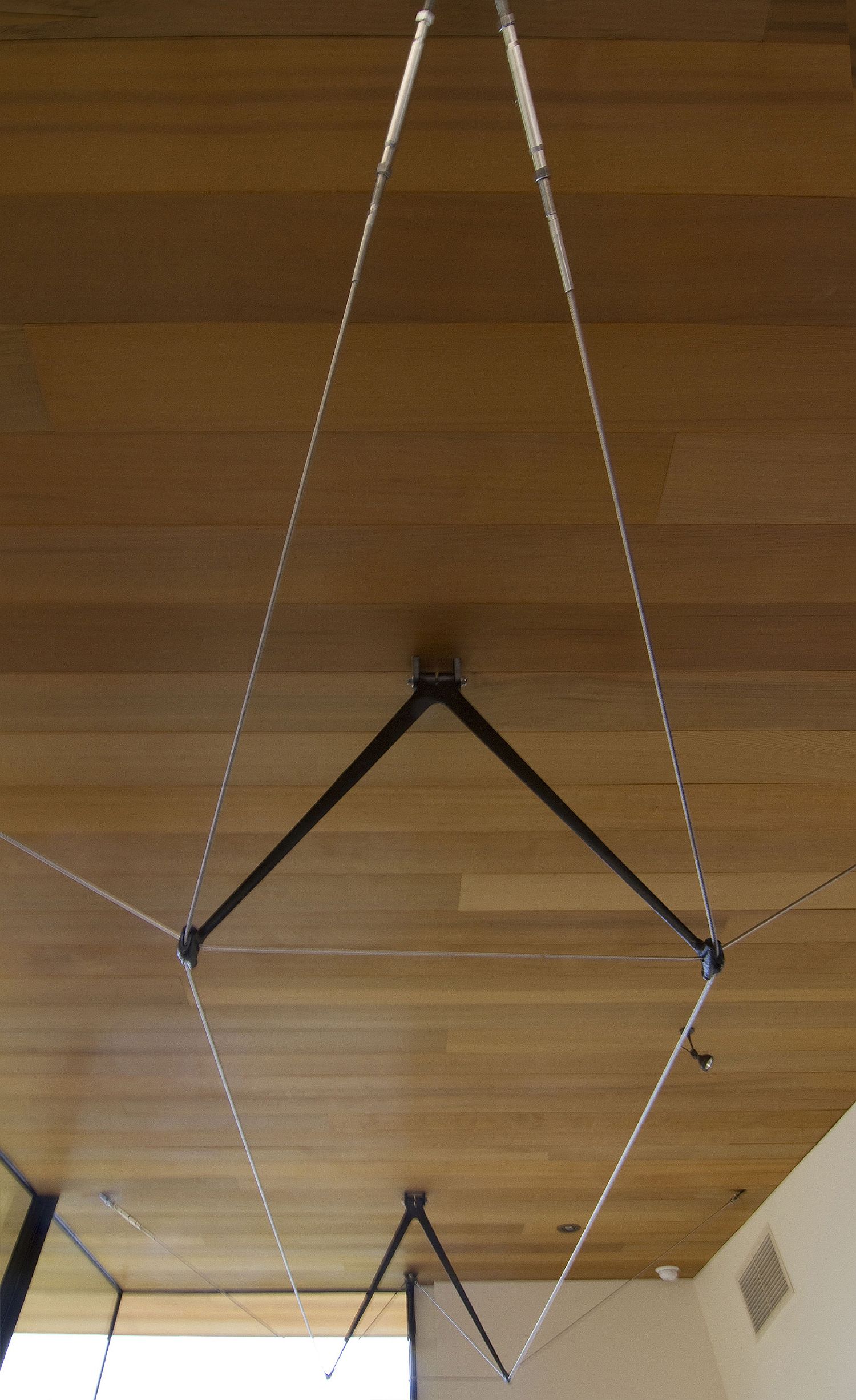 Cast steel struts in a three-dimensional cable truss system support the cantilevered roof