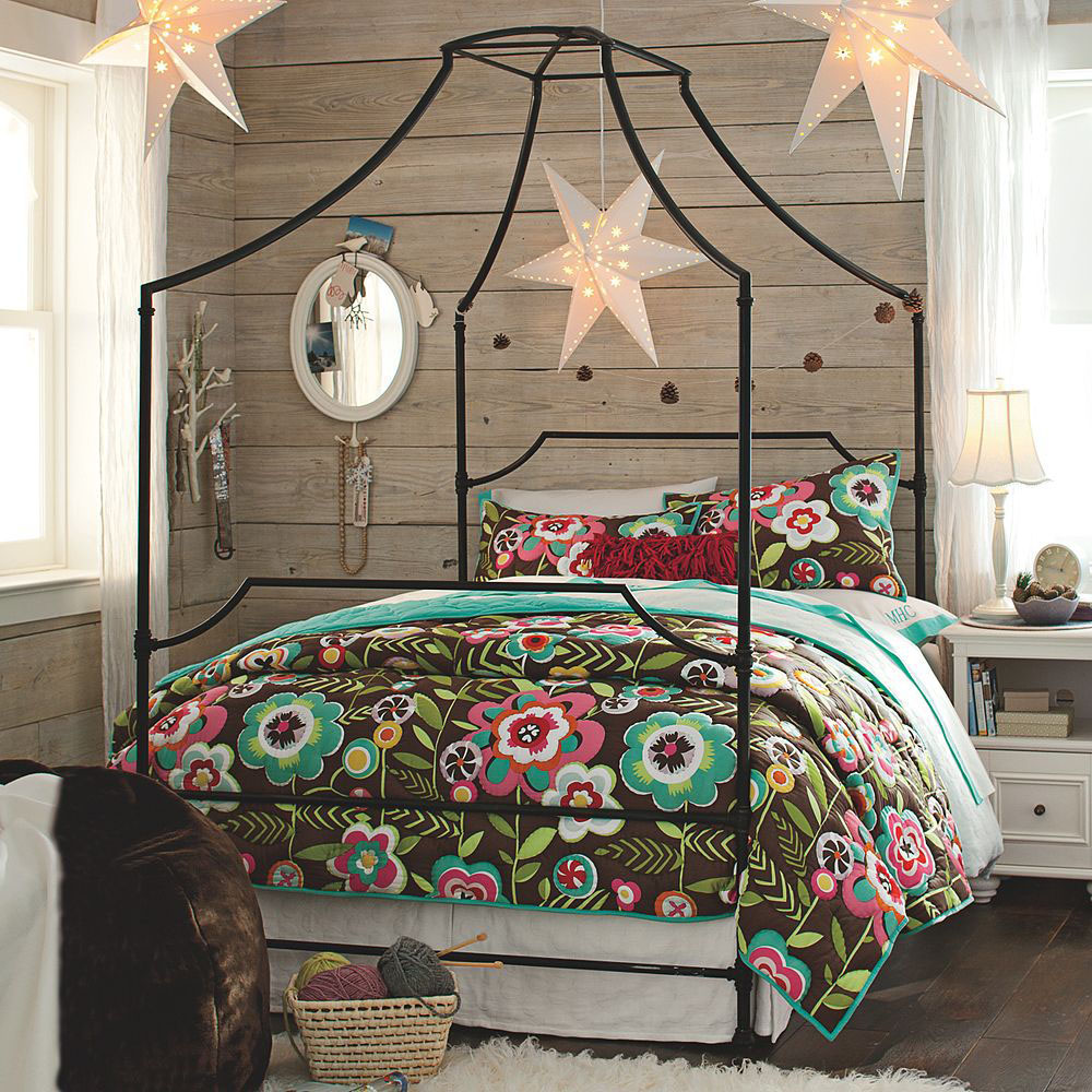 Colorful four poster bed in a bedroom full of textures