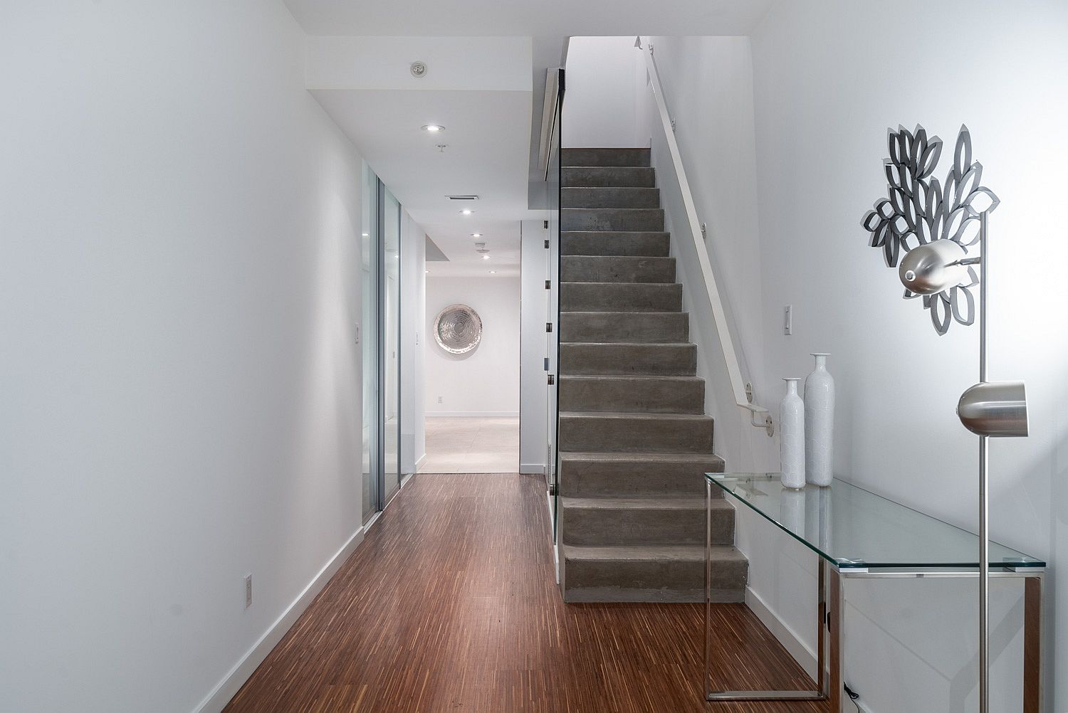 Concrete stairway with glass frame railing inside the Vancouver loft