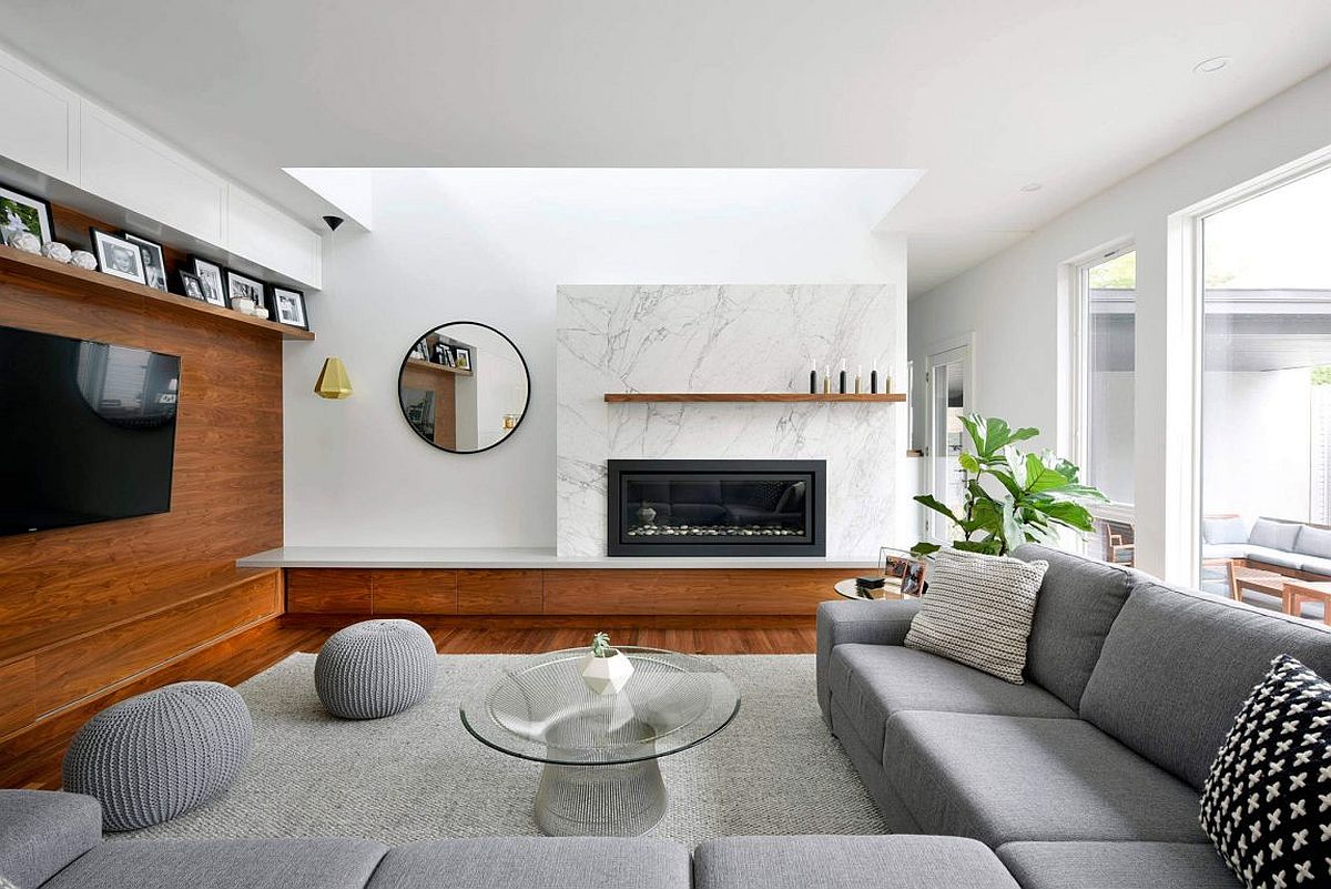 Contemporary living room in white and gray with marble fireplace and wooden accent wall