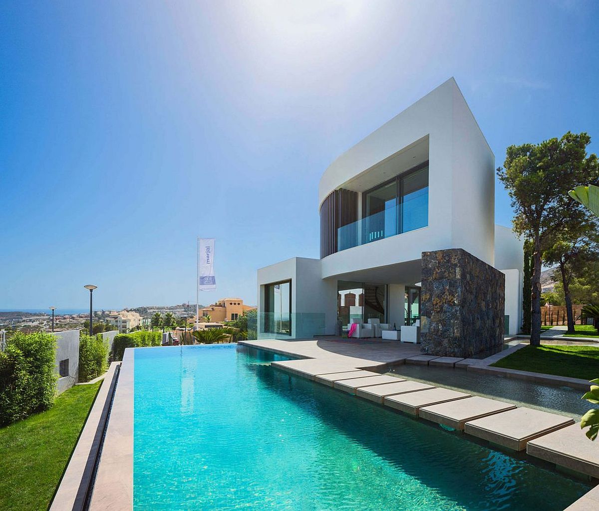 Contemporary pool design with stepping stones adds to the style of the Spanish home