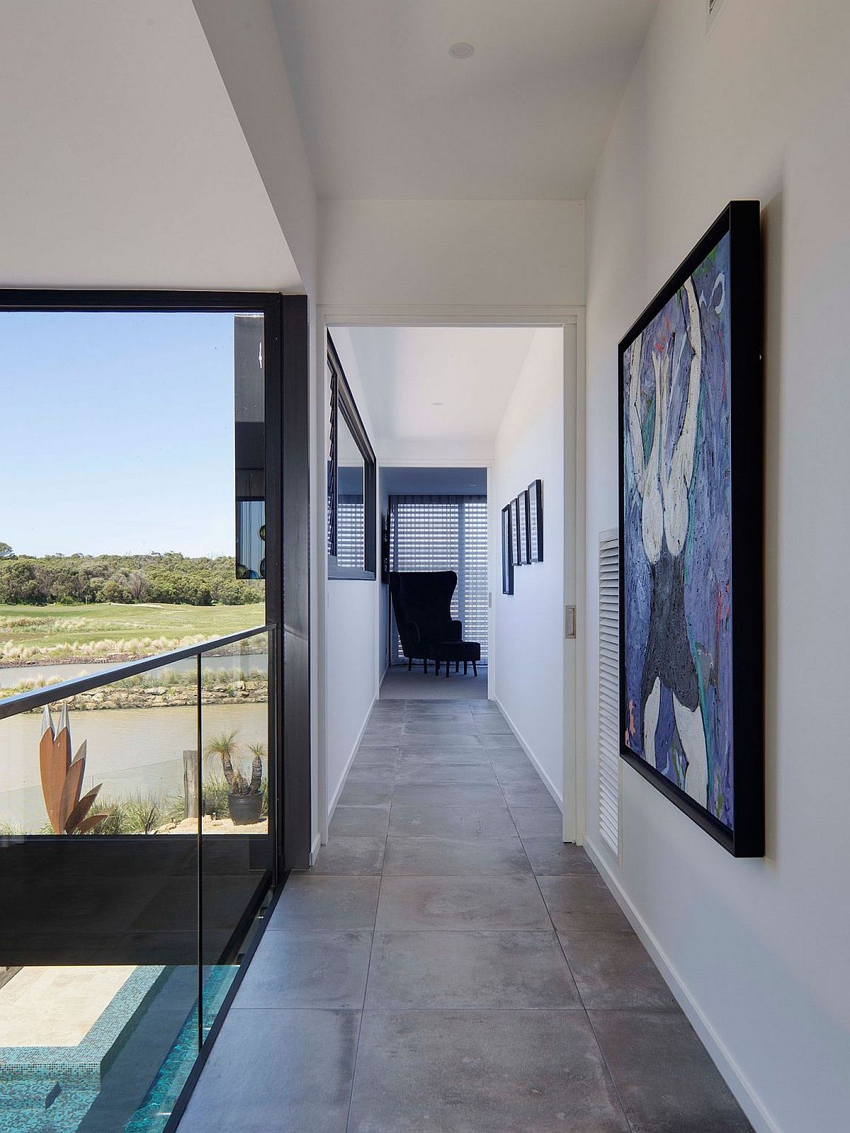 Corridor of the home with a view of the pool and garden below