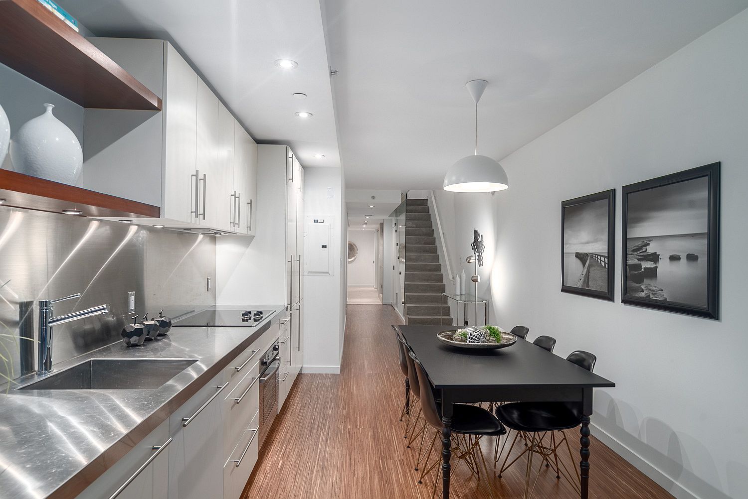 Dark dining table in the kitchen anchors it beuatifully