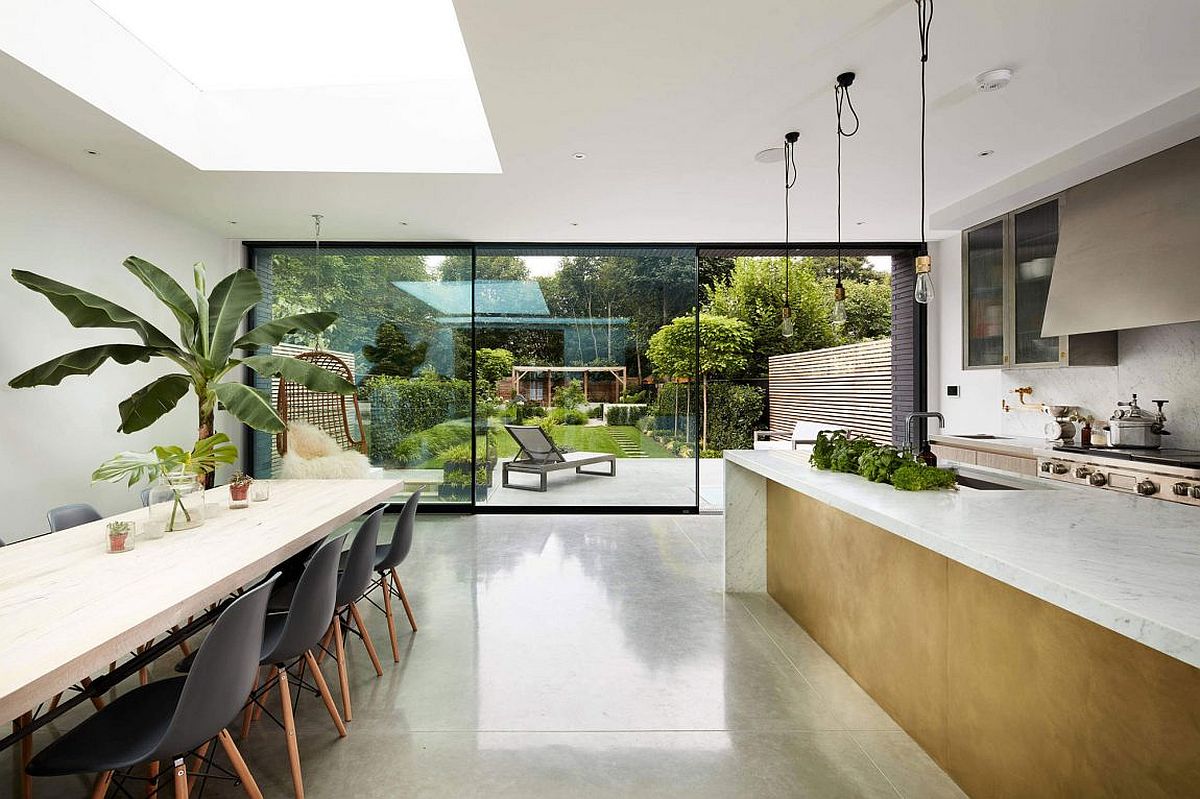 Exquisite contemporary kitchen and dining connected with the lush green courtyard