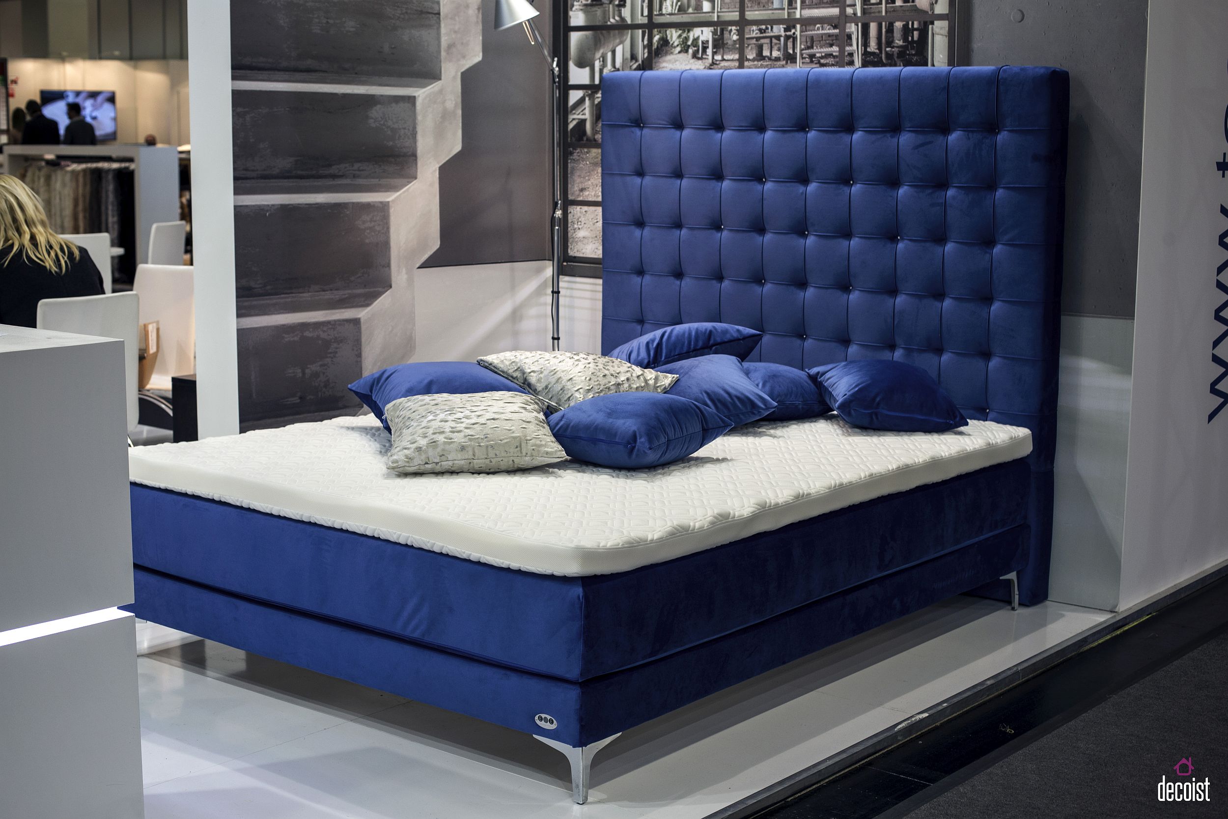 Exquisite tufted headboard in bold blue gives this bed its unique look