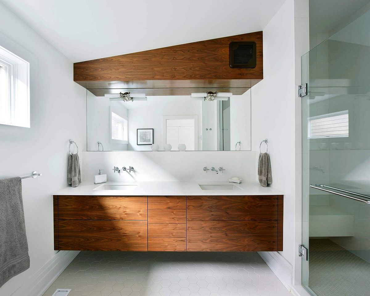 Floating wooden vanity in the bathroom with a sparkling white coutertop
