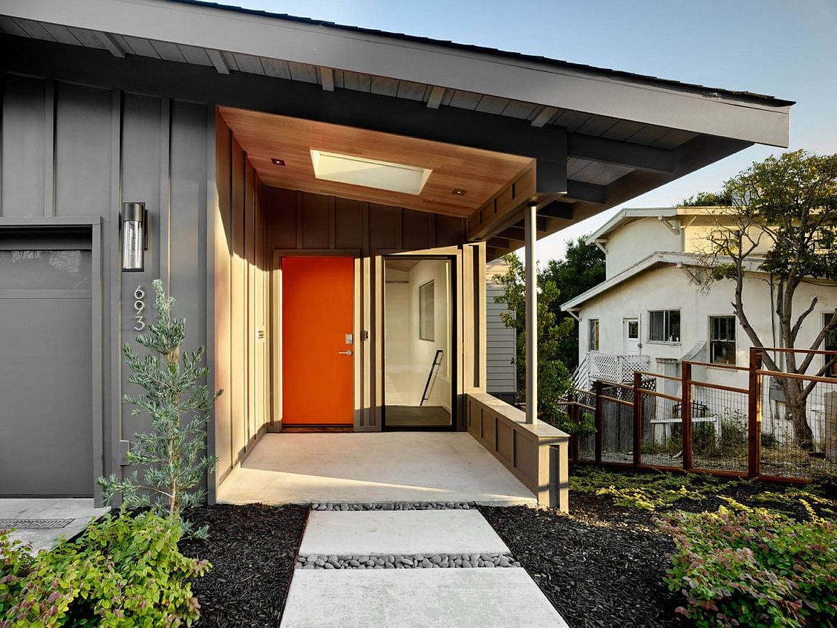 Gary exterior of the home with a gorgeous orange door and a cool entryway