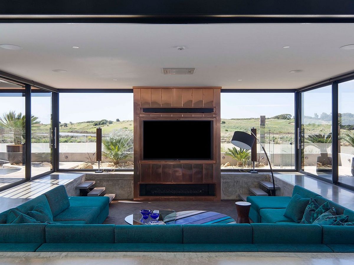 Glass walls, media unit, sunken seating create a gorgeous home cinema experience
