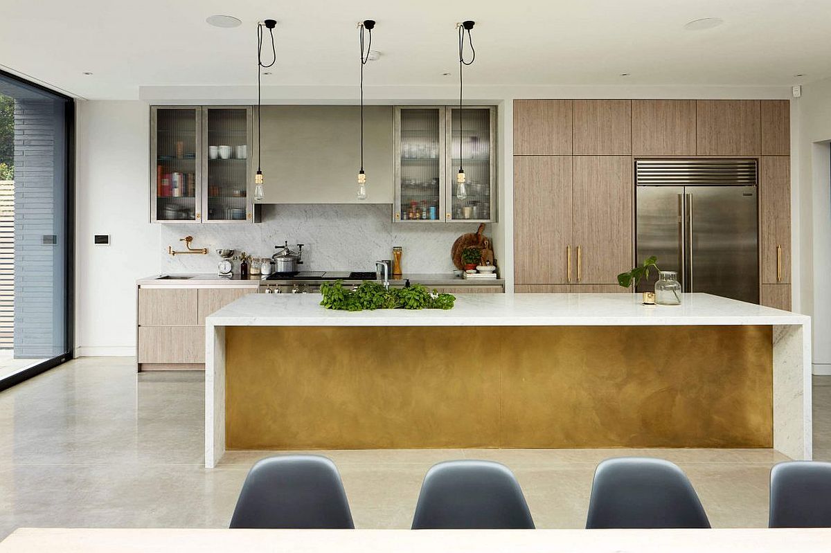 Large kitchen island with a white countertop and glass cabinets in the backdrop