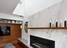 Marble-around-the-fireplace-along-with-the-wooden-TV-wall-bring-in-textural-contrast-217x155