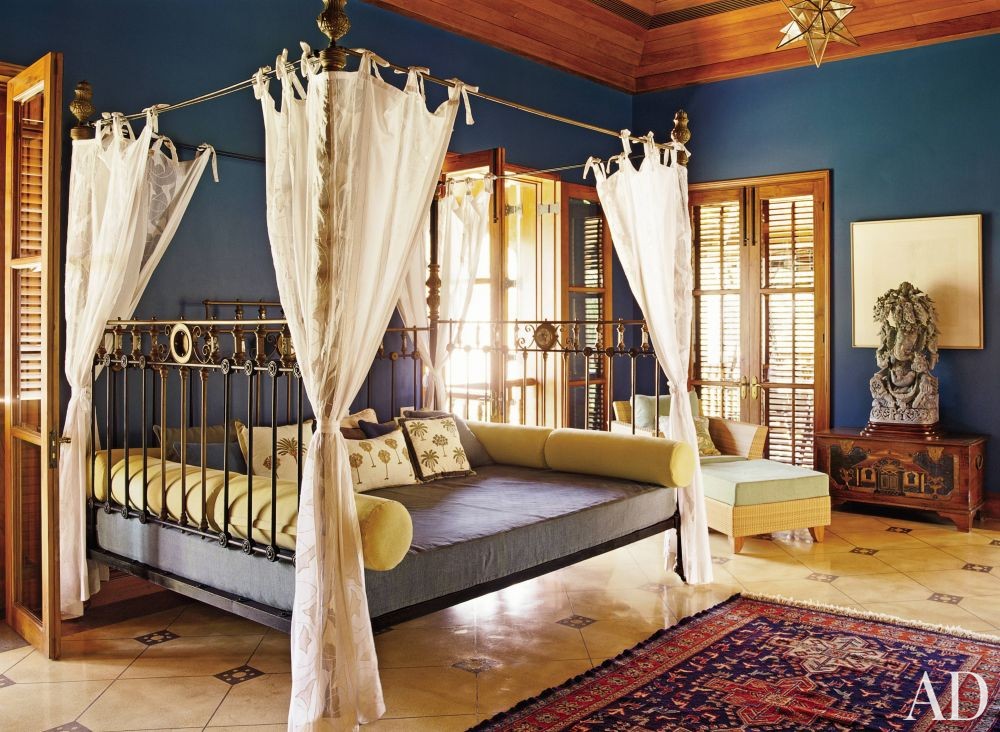 Metallic four poster bed in a bohemian bedroom