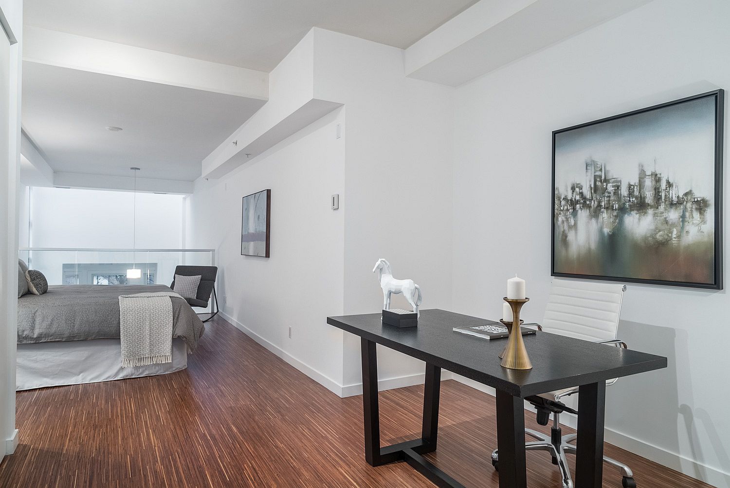 Mezzanine level bedroom and home workspace with an open, light-filled aura