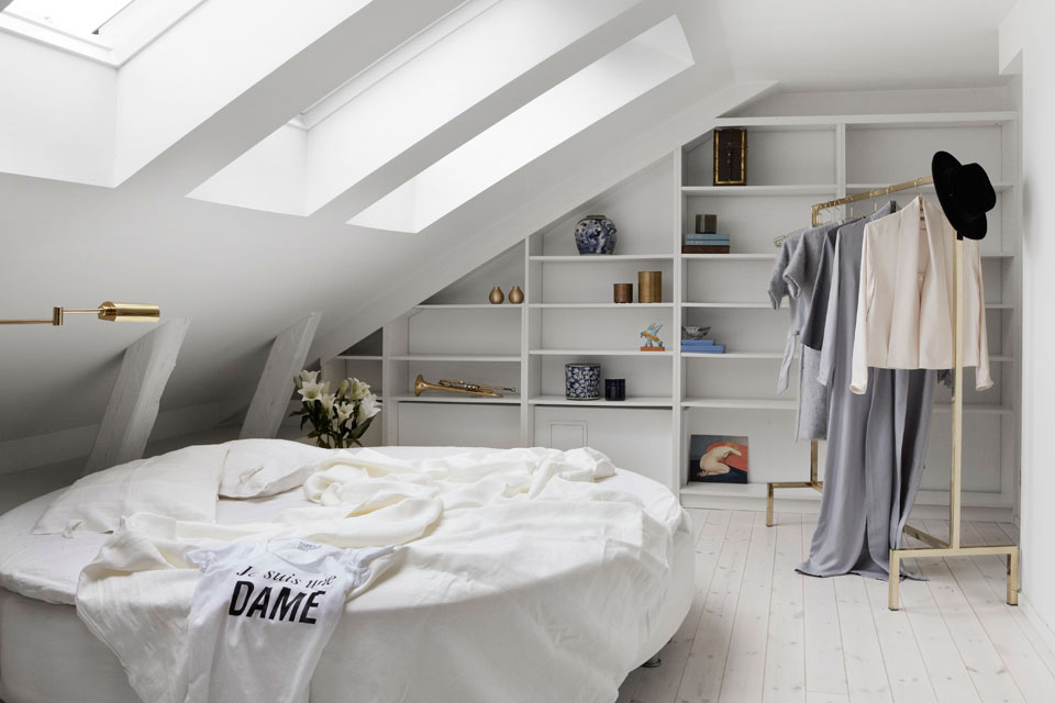 Minimal attic bedroom with a round bed