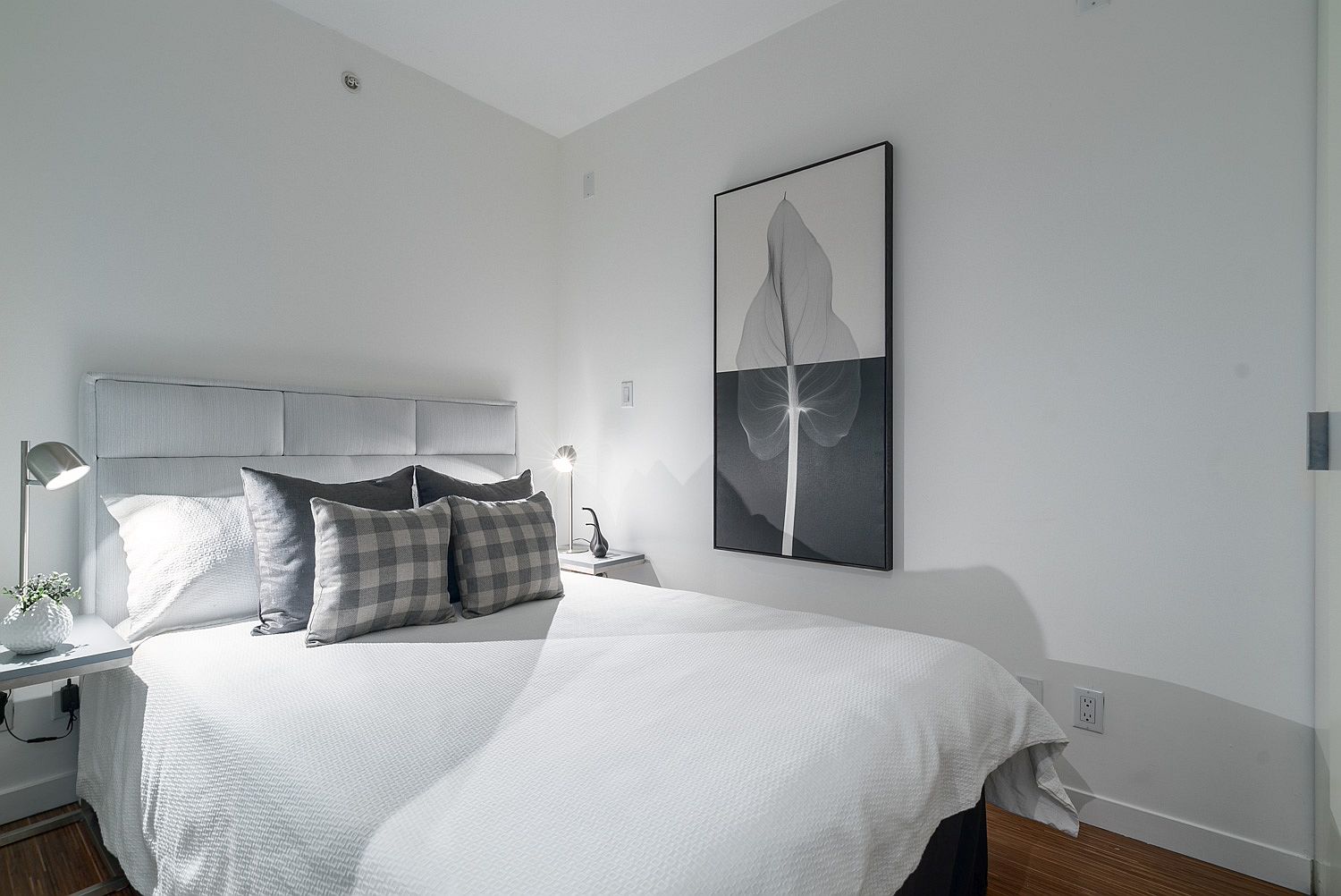 Modern bedroom in gray and white inside the two-level Vancouver loft