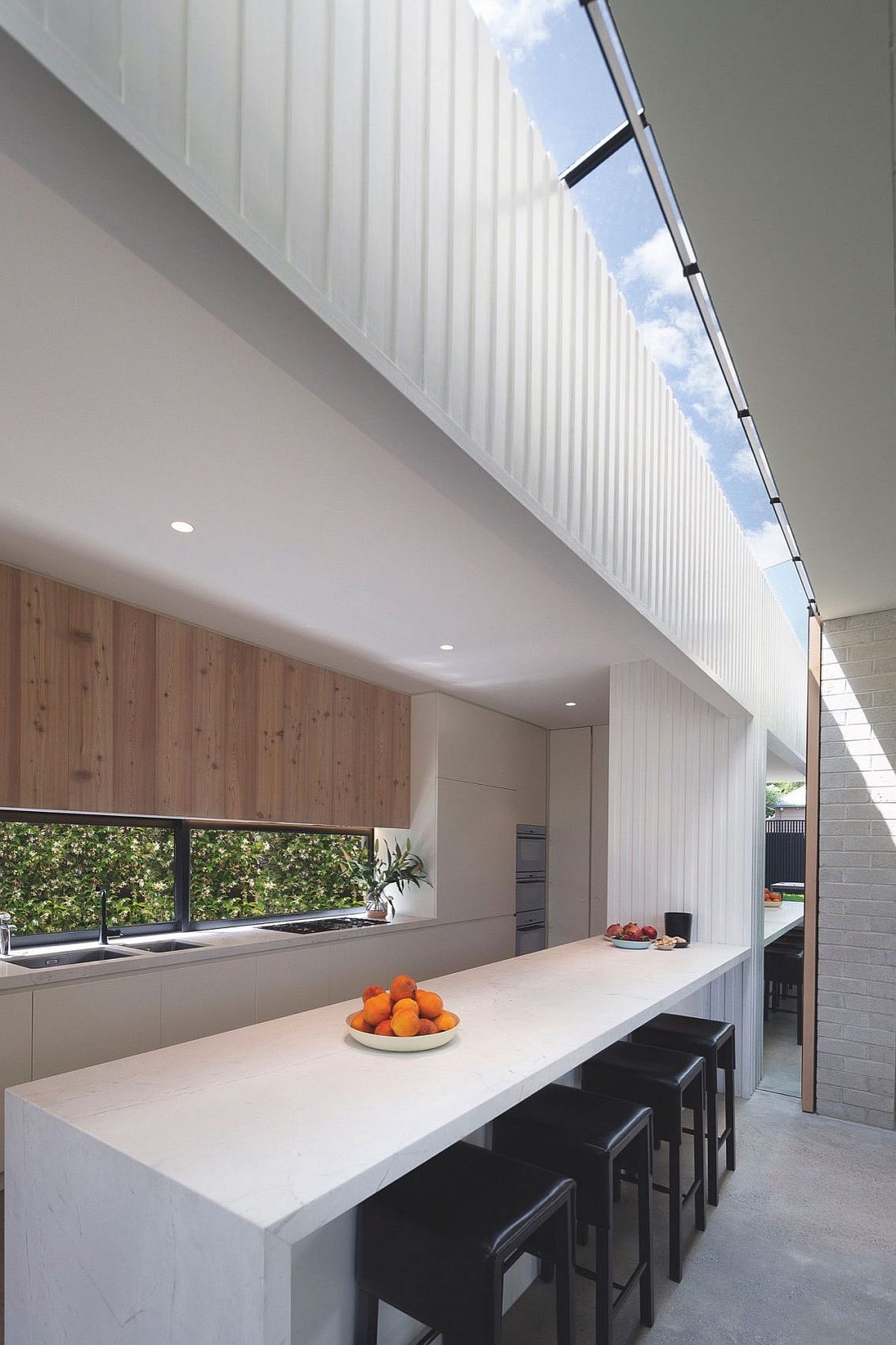 Modern kitchen in white with window above the counter