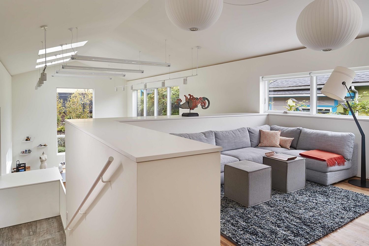 Modern lantern style pendant lights in white for mezzanine level sitting area