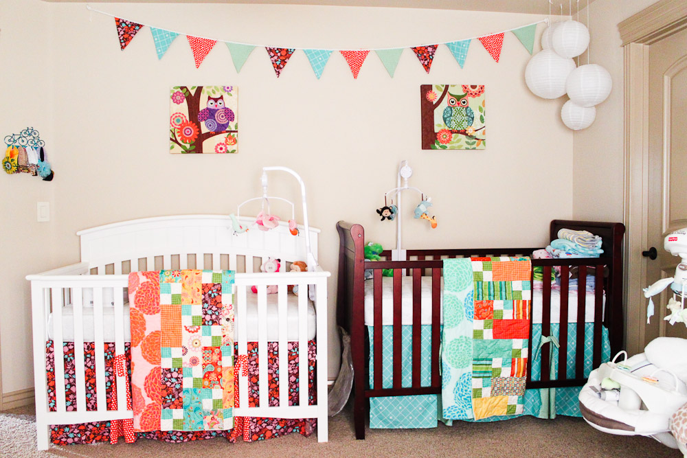 Nursery with two differently colored cribs