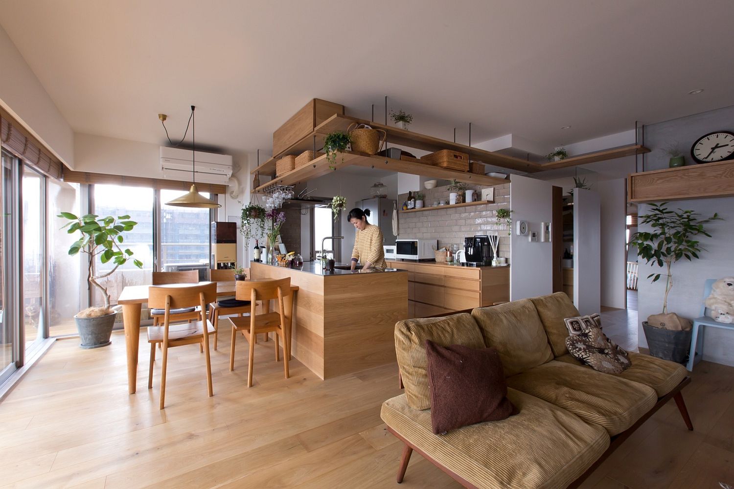 Open living area with dining and corner kitchen inside the Japanese home