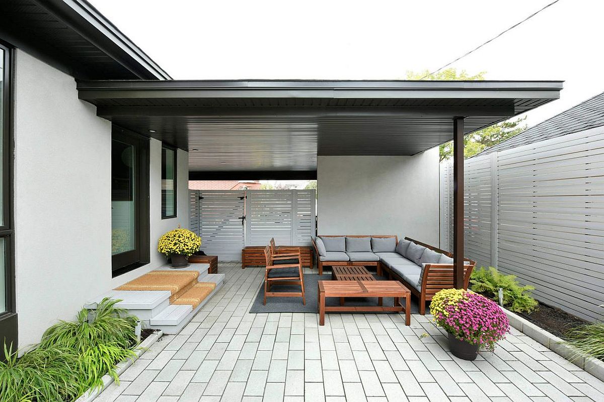 Pergola structure offers perfect shade to the relaxing outdoor hangout in neutral hues