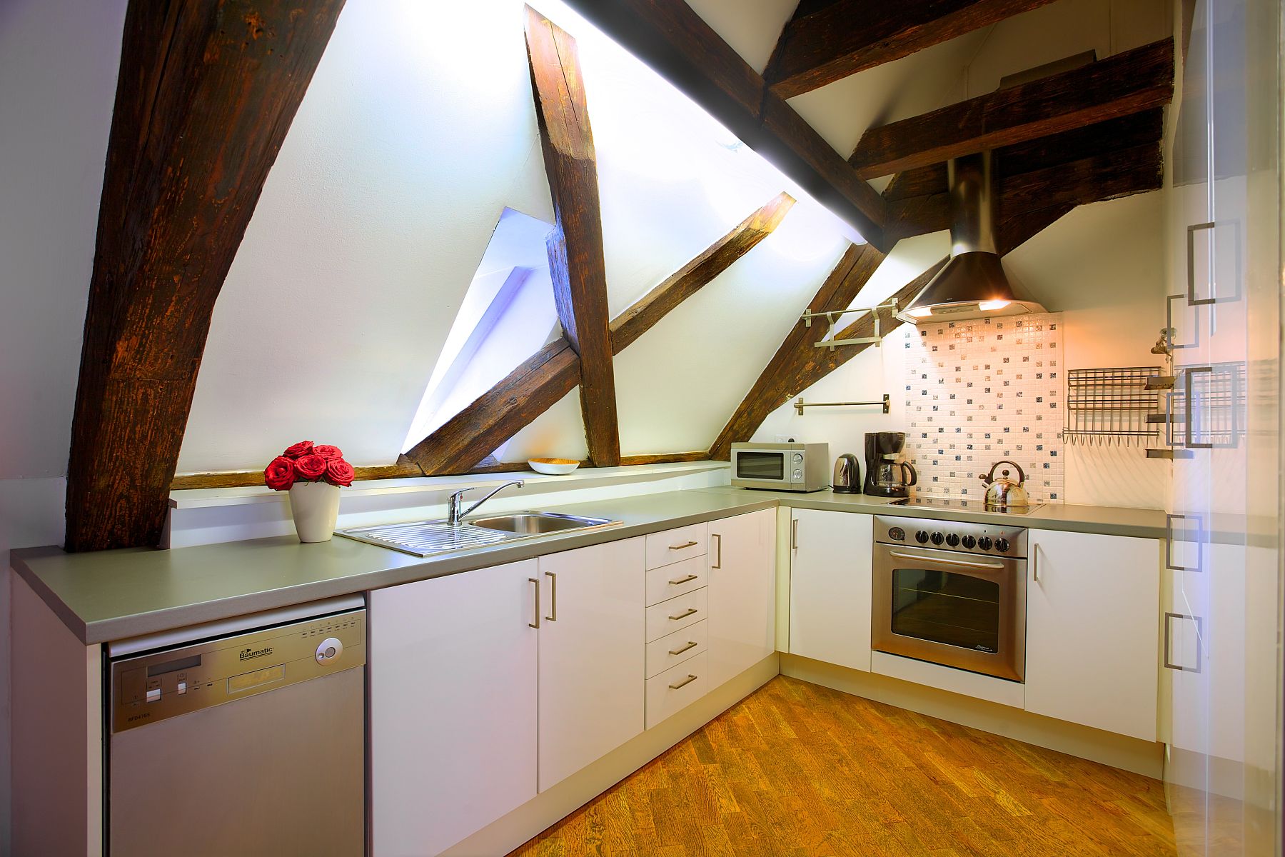 Picture-perfect attic kitchen with minimal styling and silvery tones