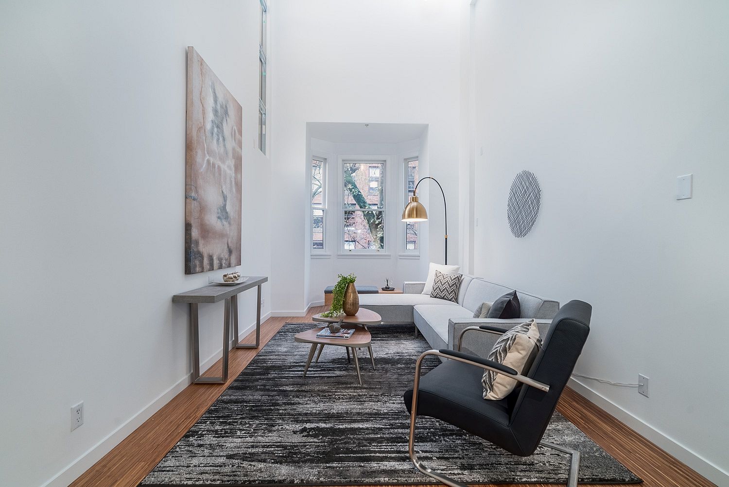 Raised living room with metallic accents and gray and white color scheme