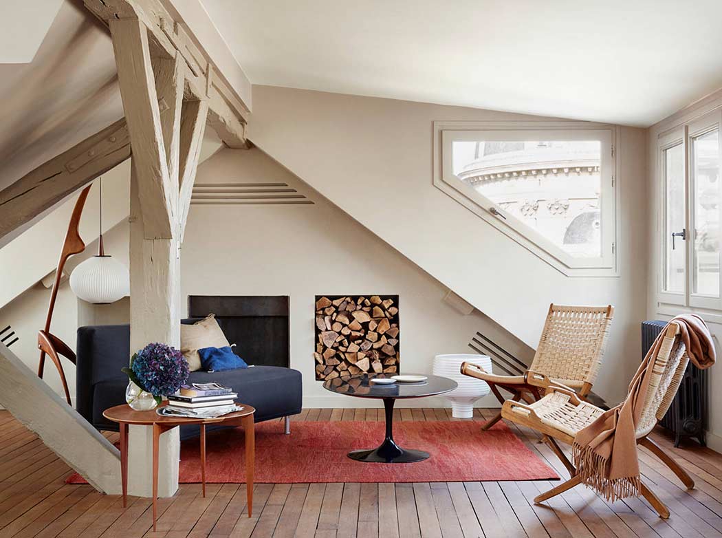 Relaxing attic living room with cream colored walls and modern fireplace