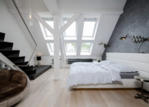 Roomy-attic-bedroom-with-neutral-styling-and-minimal-furnishing-217x155