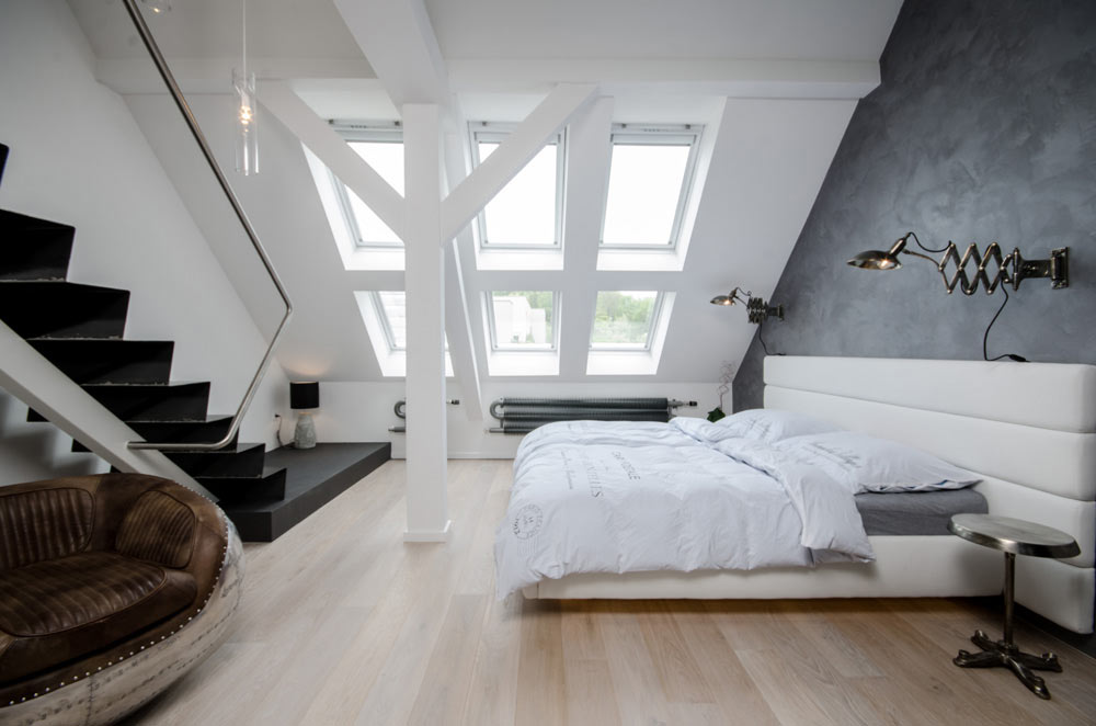 Roomy attic bedroom with neutral styling and minimal furnishing