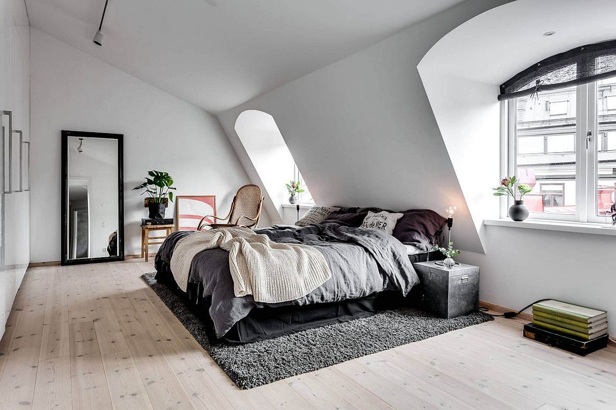 Scandianavian-bedroom-with-large-mirror-ample-natural-light-and-a-relaxing-ambiance