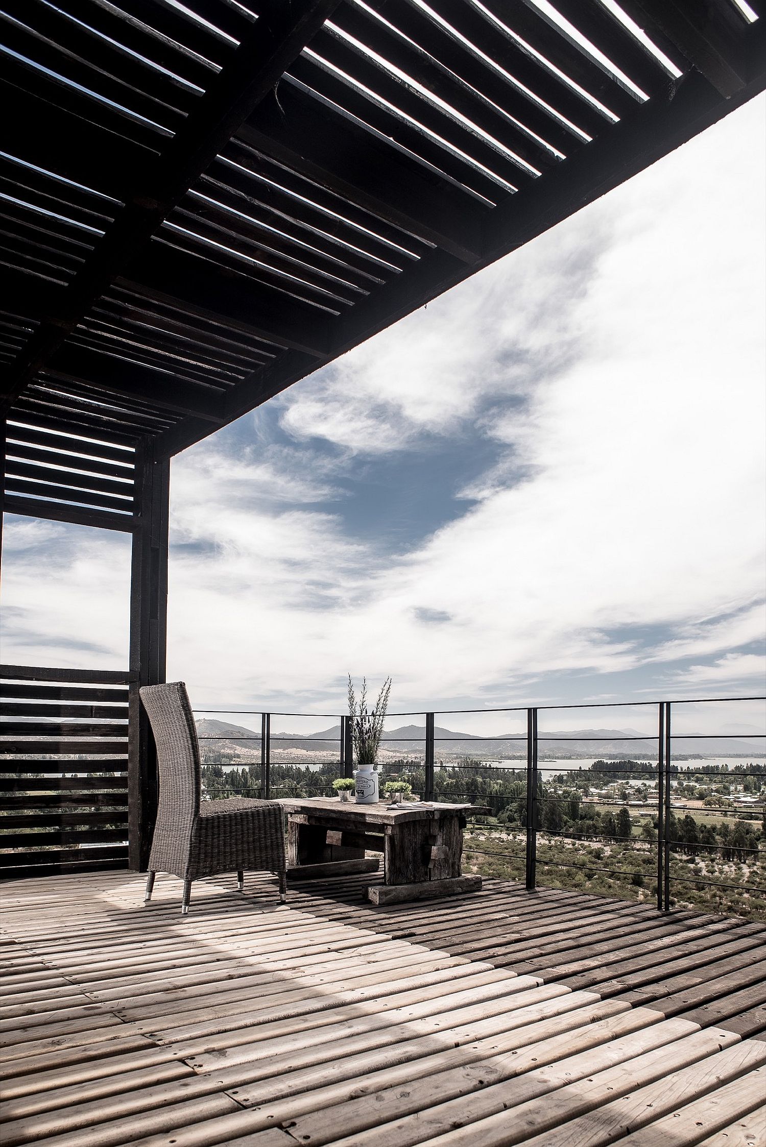 Simple and minimal wooden terrace overlooking the landscape the lake beyond