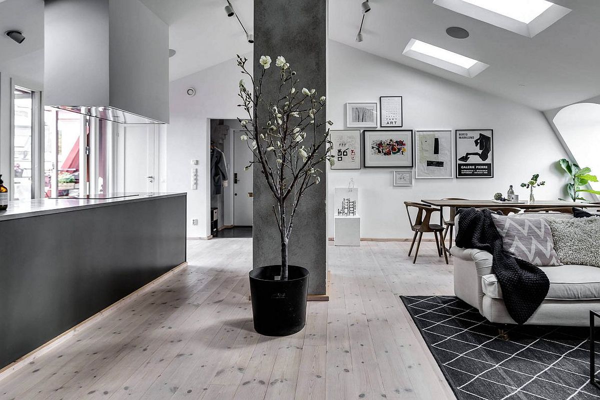 Skylight and windows bring natural light into the stylish Scandinavian apartment