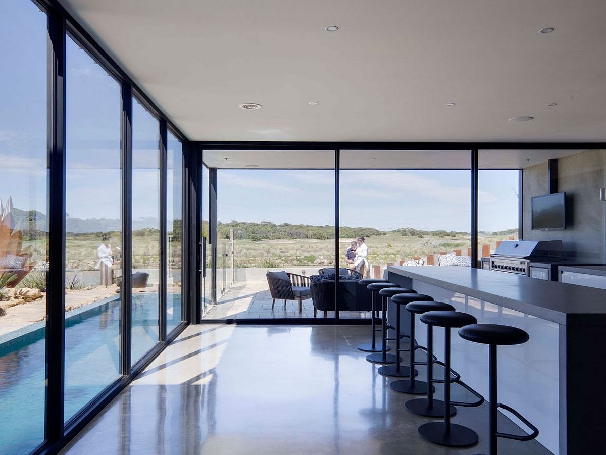 Sliding glass doors connect the kitchen with the outdoors