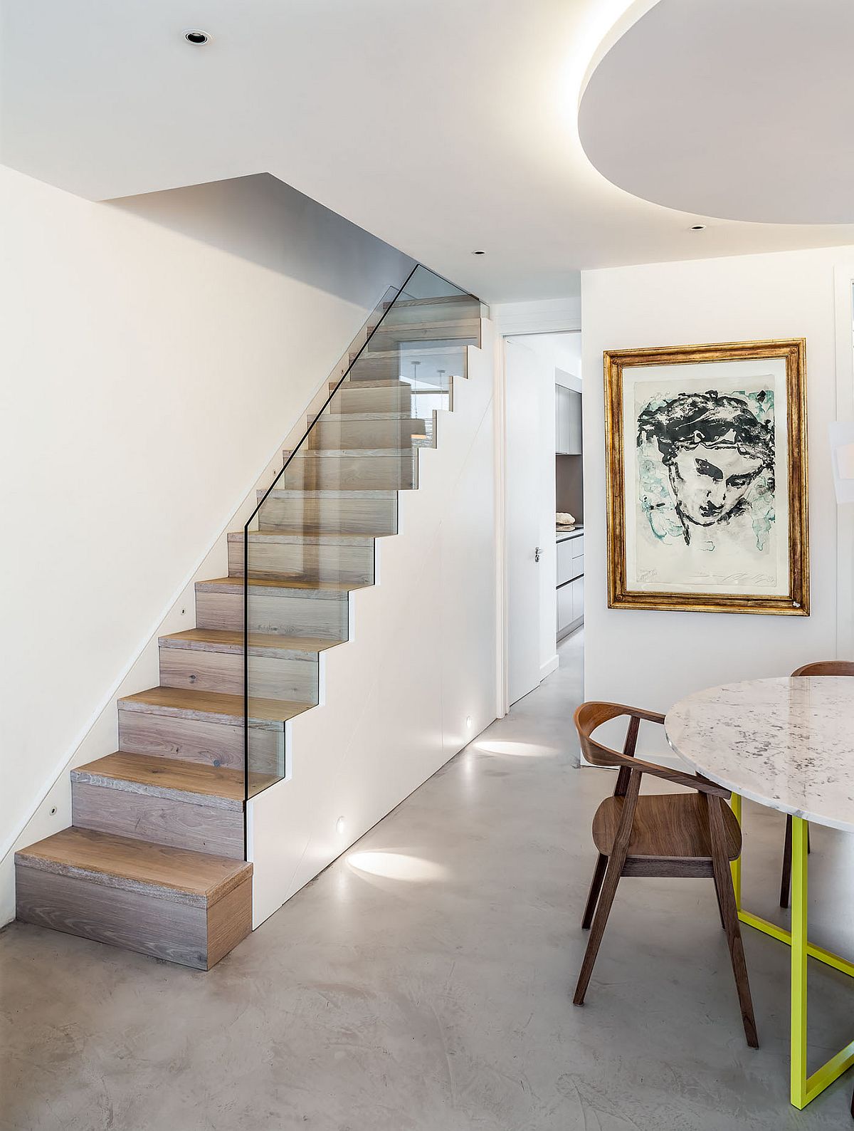 Small and stylish staircase with glass railing and hidden storage