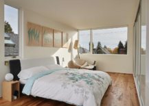 Small-bedroom-in-white-with-wooden-flooring-and-a-series-of-windows-that-bring-in-natural-light-217x155