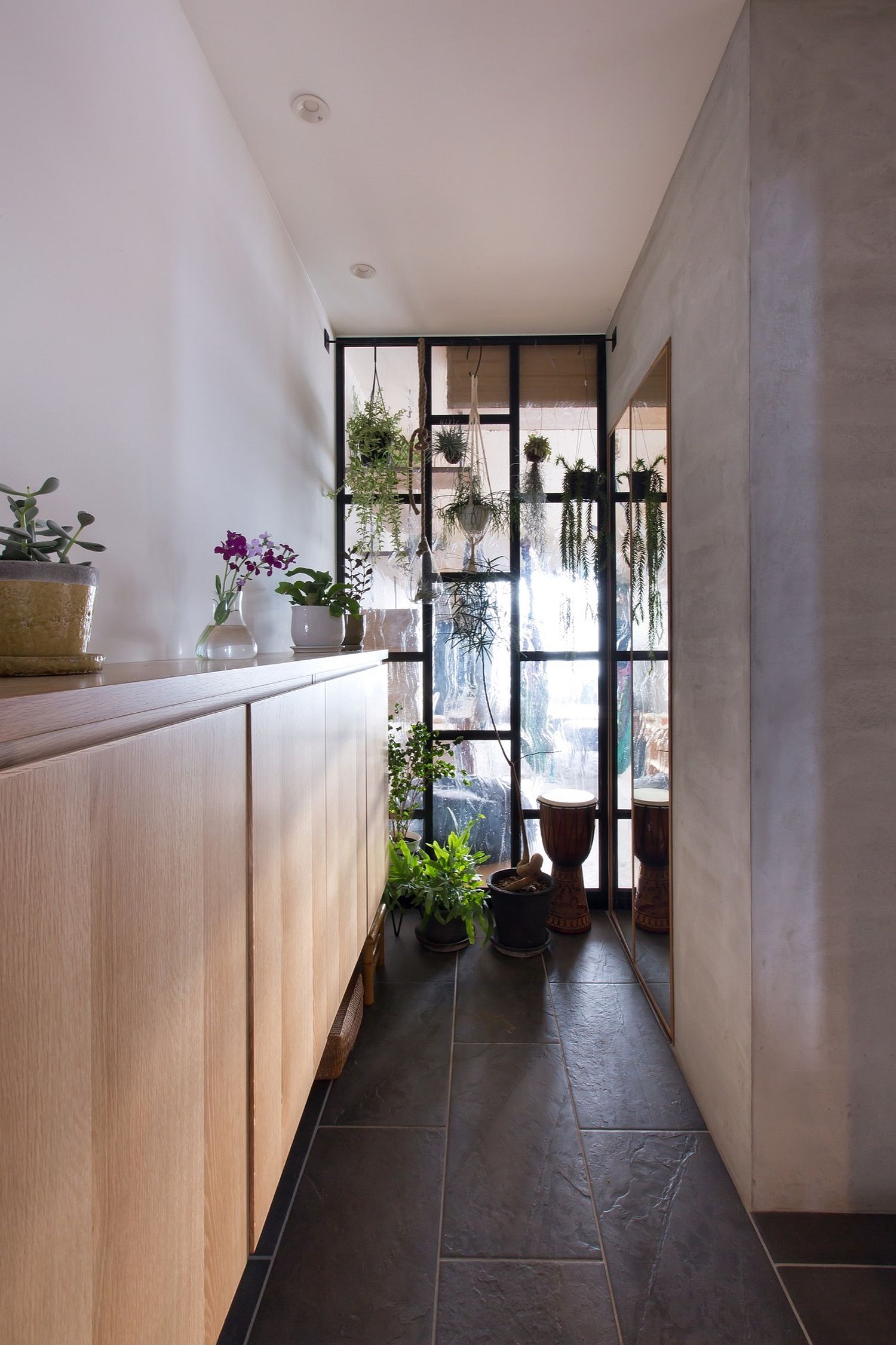 Small corridor is used to tuck away the excess using a large wooden sideboard