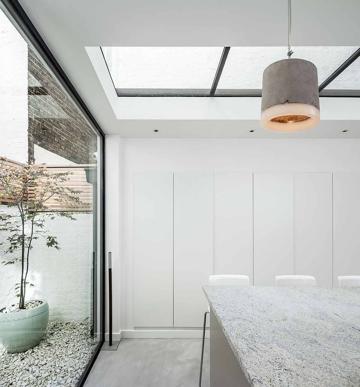 Small courtyard brinsg natural light into the revamped dining space