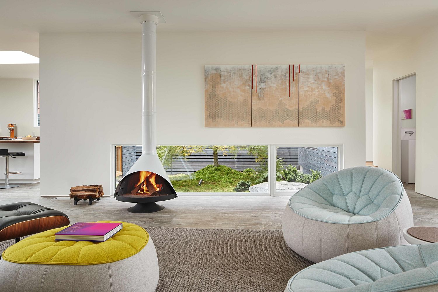 Stylish contemporary fireplace in white matches with the color scheme of the contemporary living room