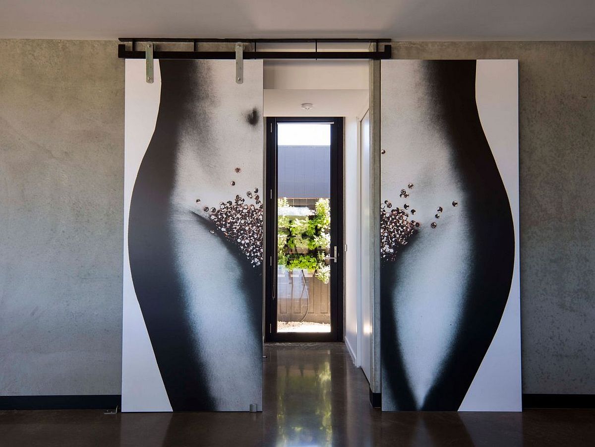 Unqiue entrance of the home with doubles doors and eye-catching wall art