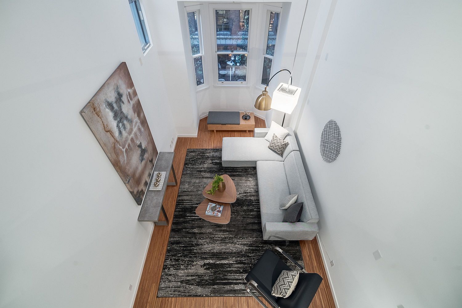 View of the lower level living area from the loft level bedroom above