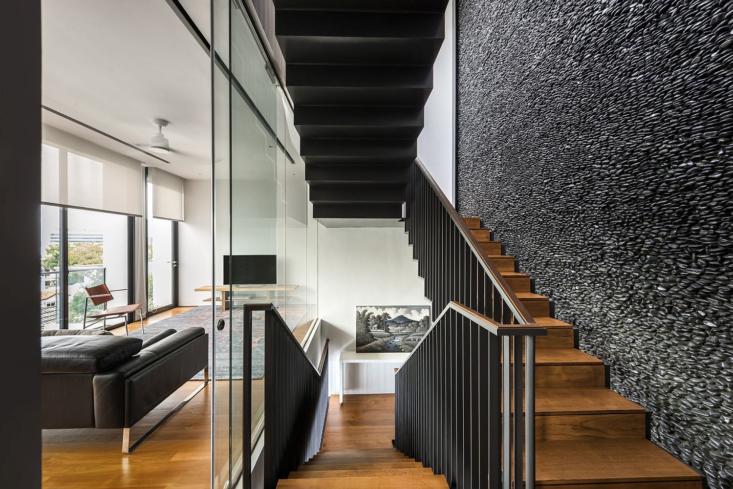 Wood and metal staircase connecting the multiple levels of the contemporary home