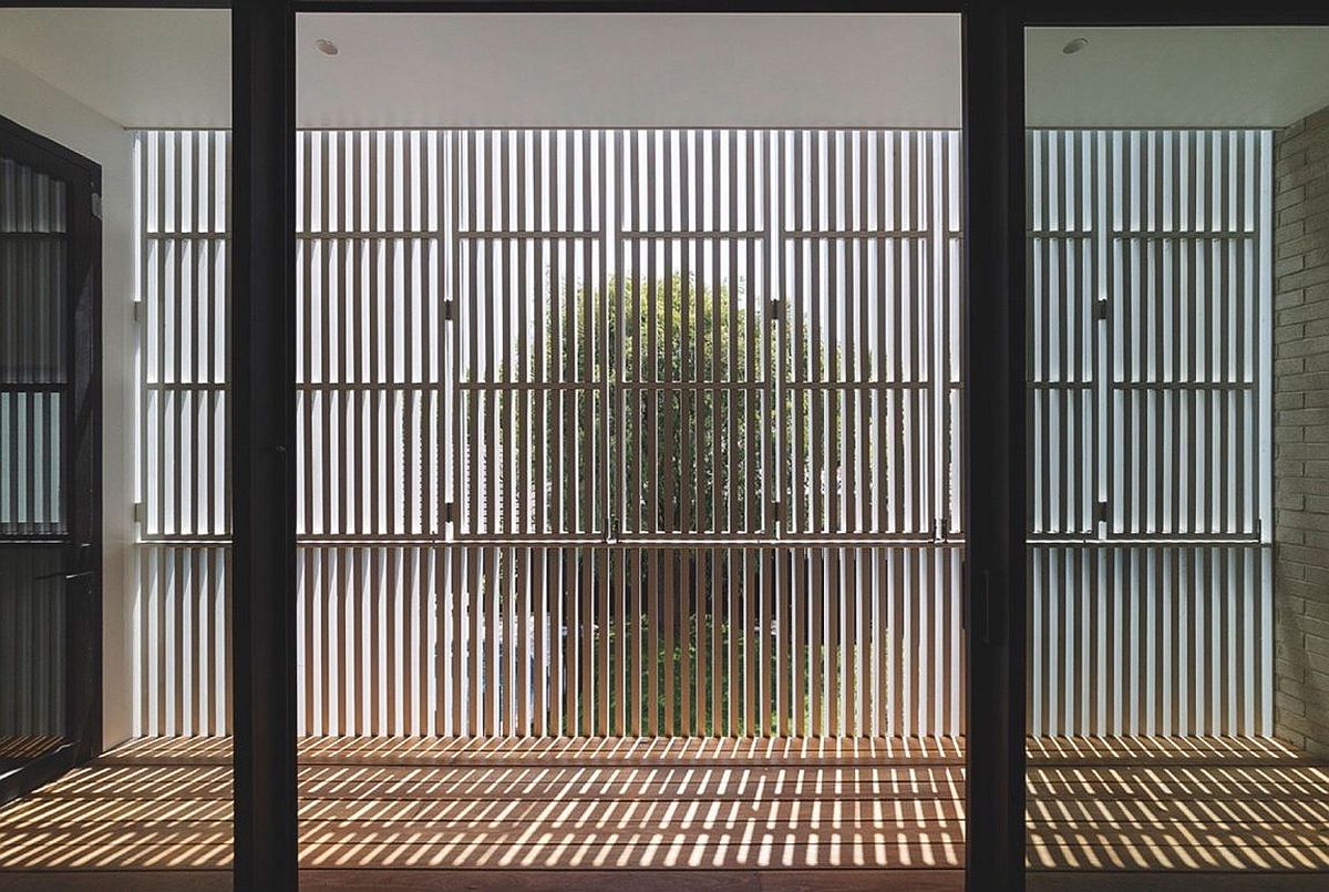 Wooden slats filter in sunlight to offer passive heating