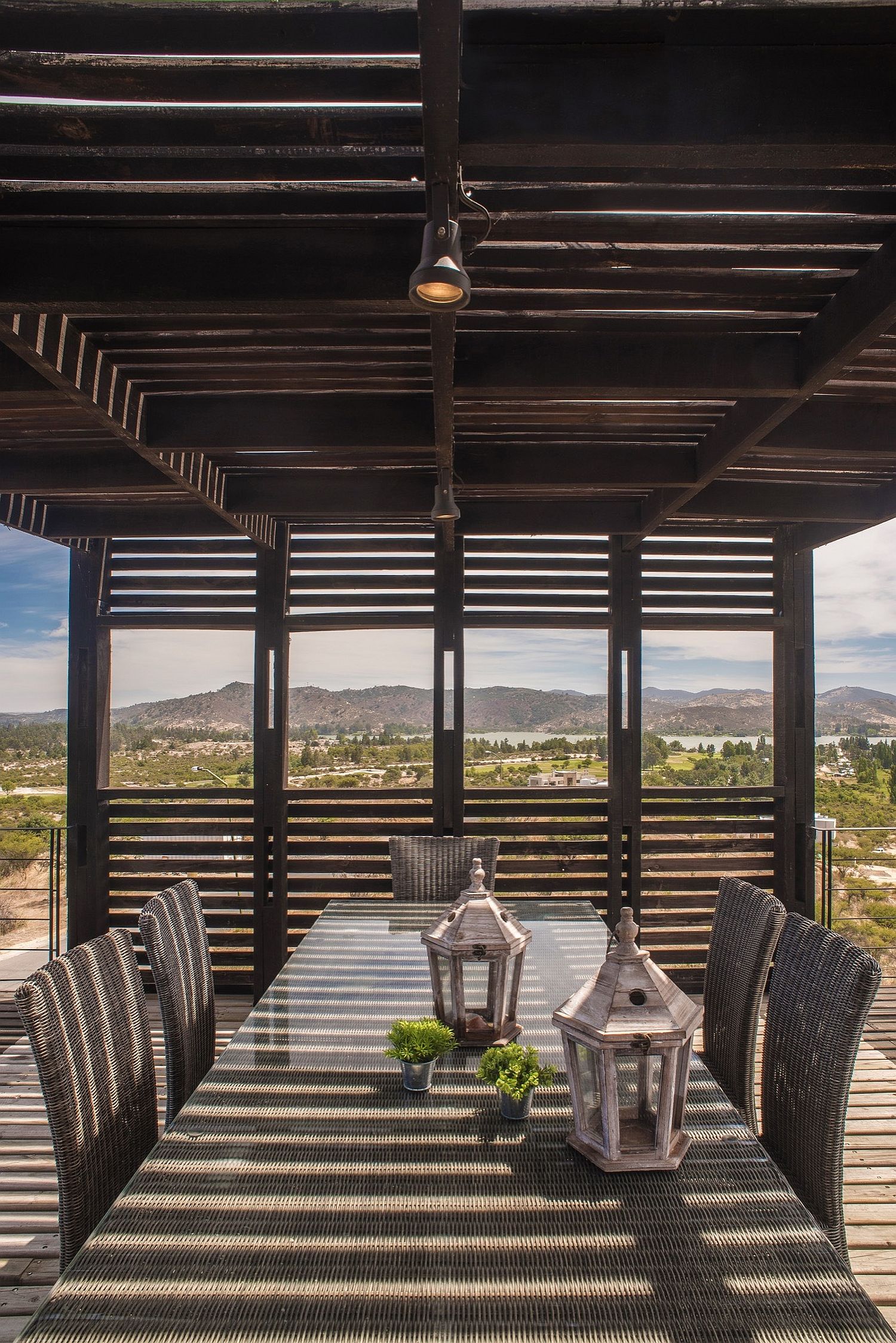 Wooden slats offer shade for the outdoor dining space